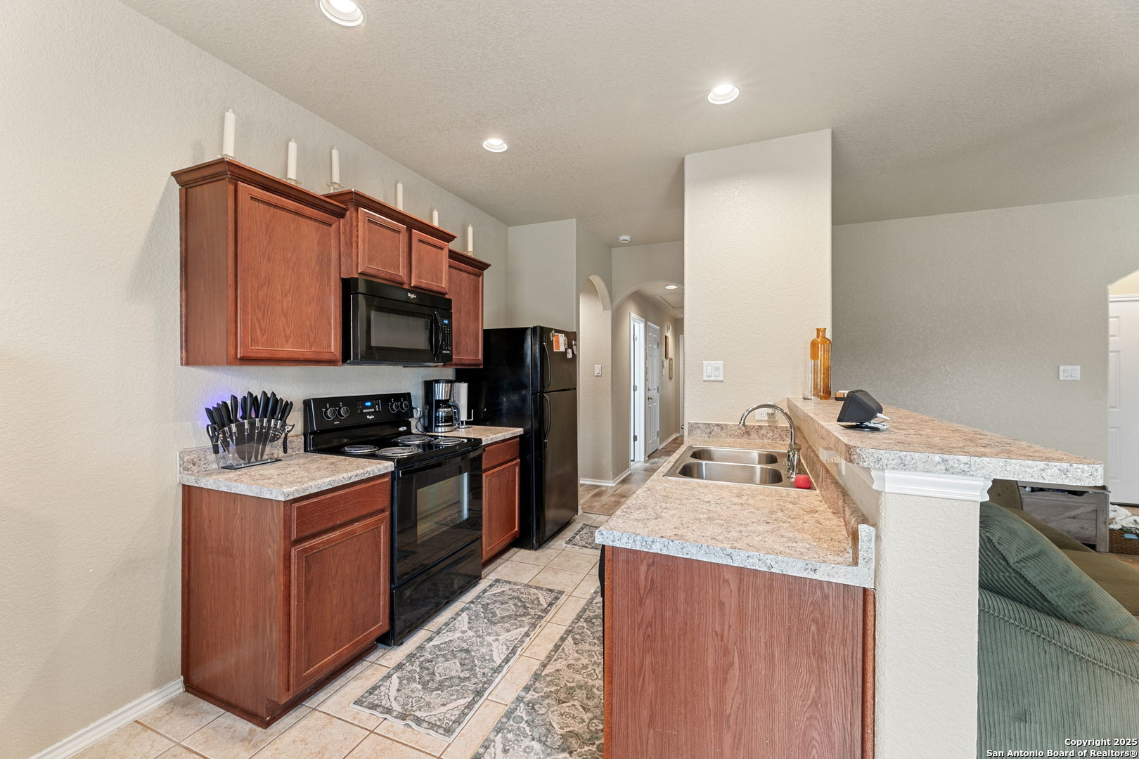 3850 Key W Way Converse, TX 78109 - Photo 12 of 24 a kitchen with a sink stove and refrigerator