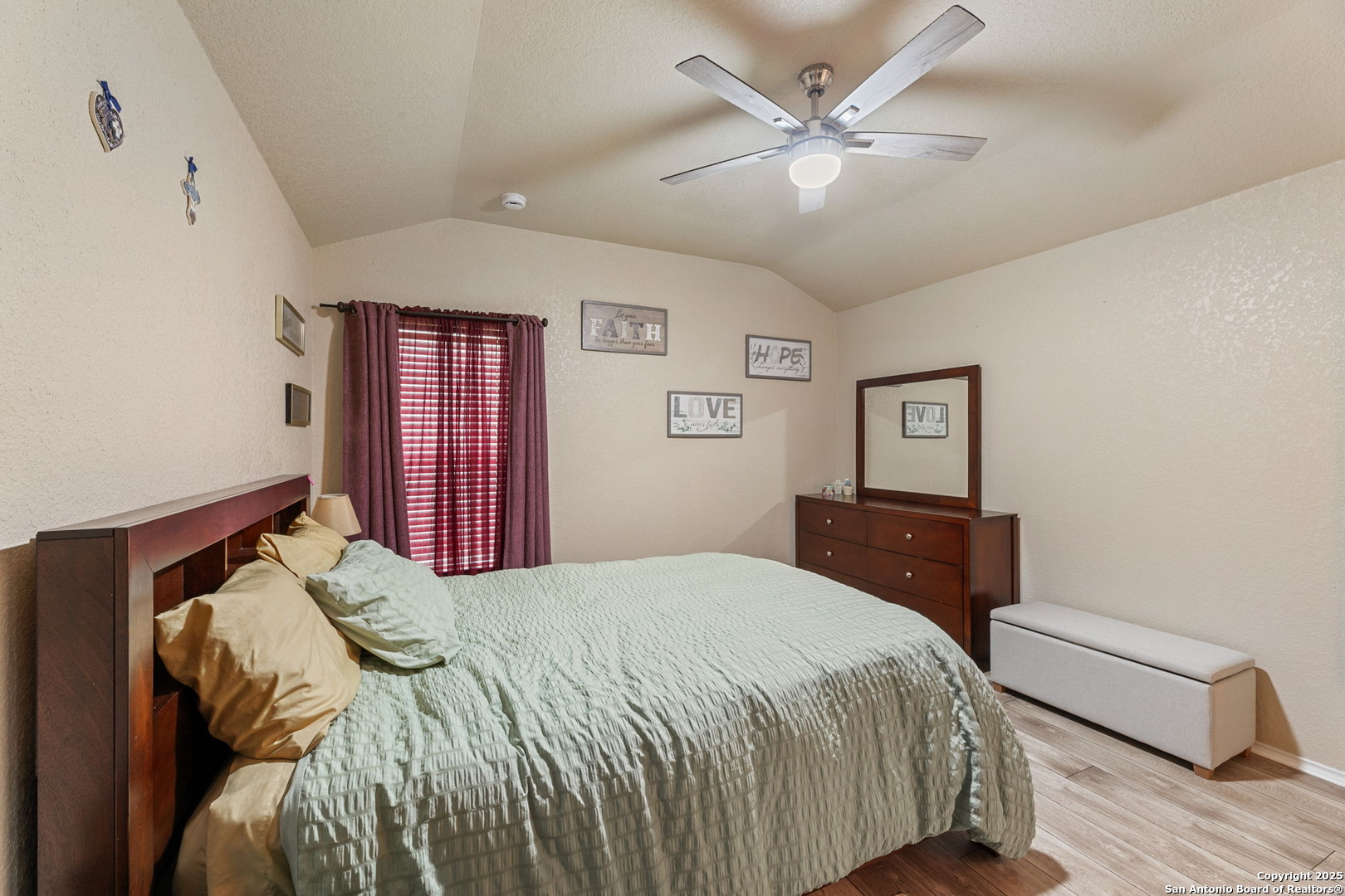 3850 Key W Way Converse, TX 78109 - Photo 16 of 24 a bedroom with a large bed and a chandelier