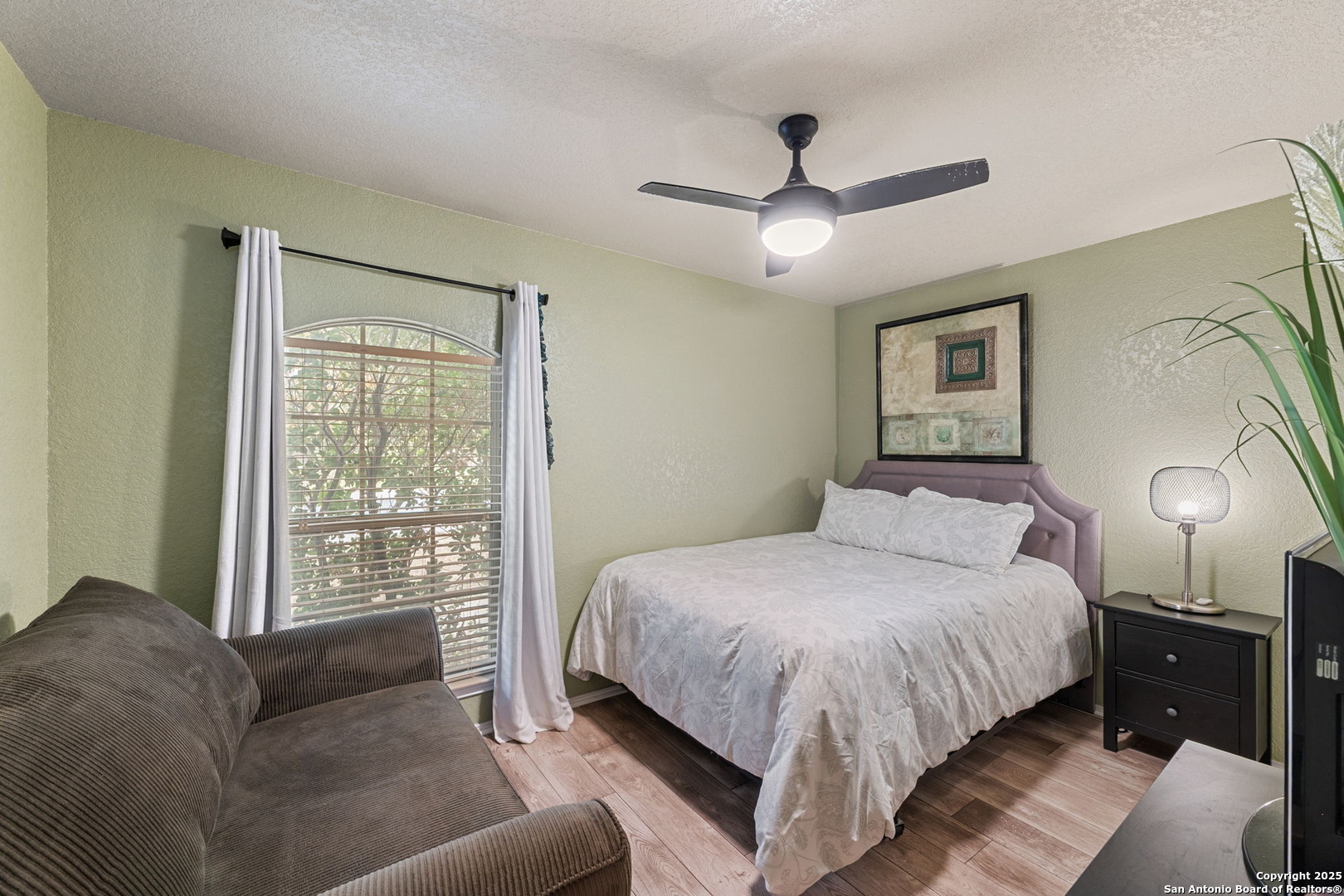 3850 Key W Way Converse, TX 78109 - Photo 18 of 24 a bedroom with a large bed and a couch