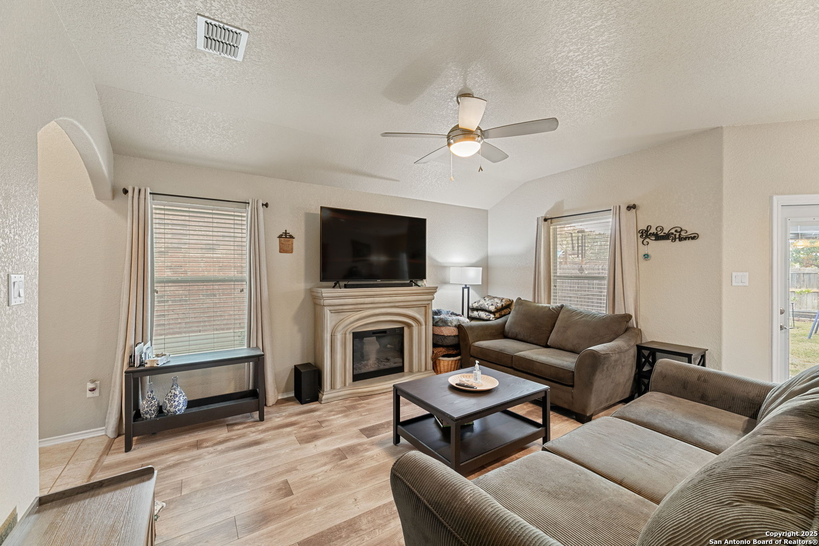 3850 Key W Way Converse, TX 78109 - Photo 5 of 24 a living room with furniture a flat screen tv and a fireplace