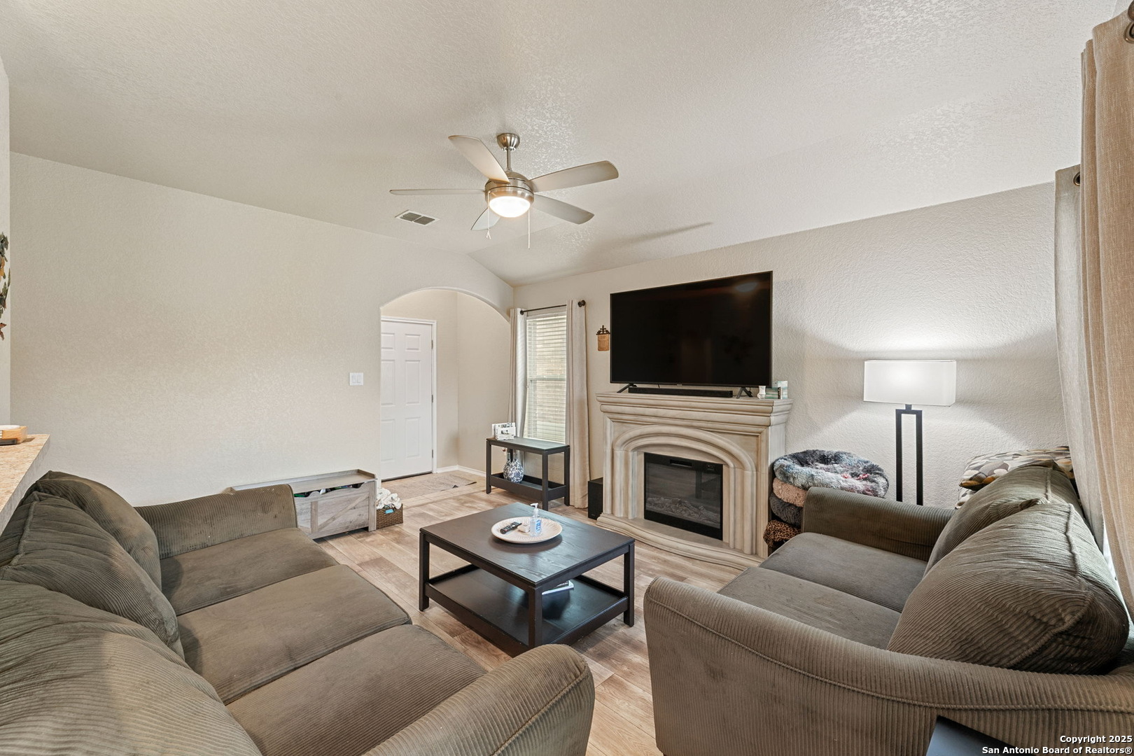 3850 Key W Way Converse, TX 78109 - Photo 7 of 24 a living room with furniture a fireplace and a flat screen tv