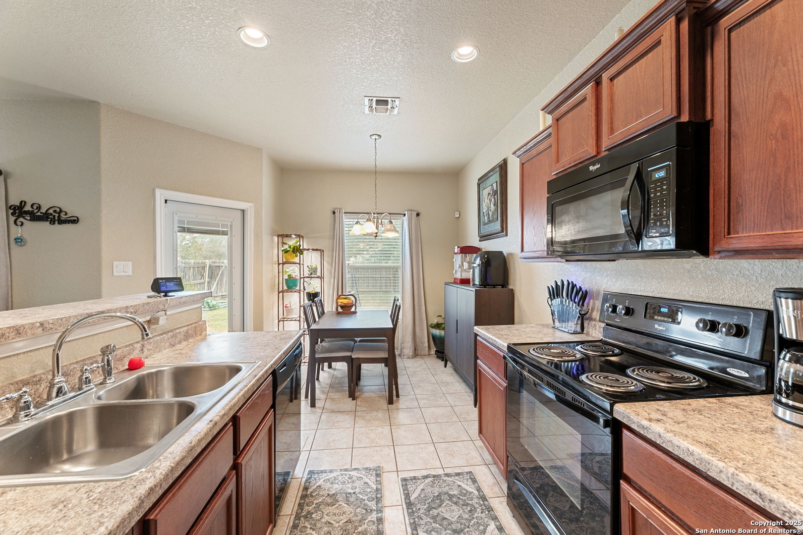 3850 Key W Way Converse, TX 78109 - Photo 10 of 24 a kitchen with a stove sink and cabinets