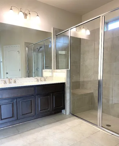a bathroom with a shower and a sink