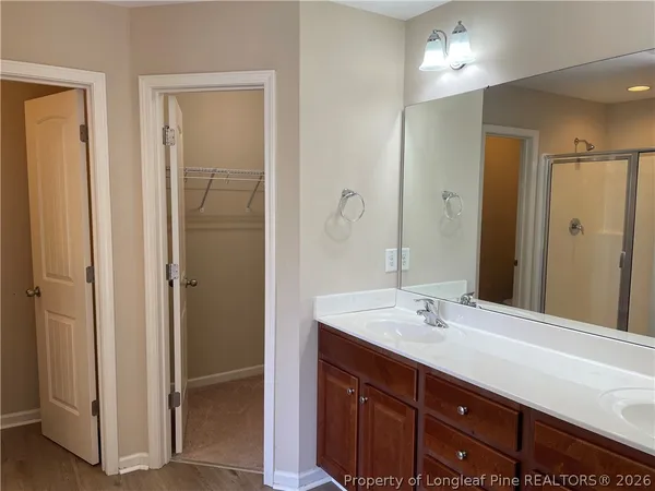 a bathroom with a sink double vanity and a mirror