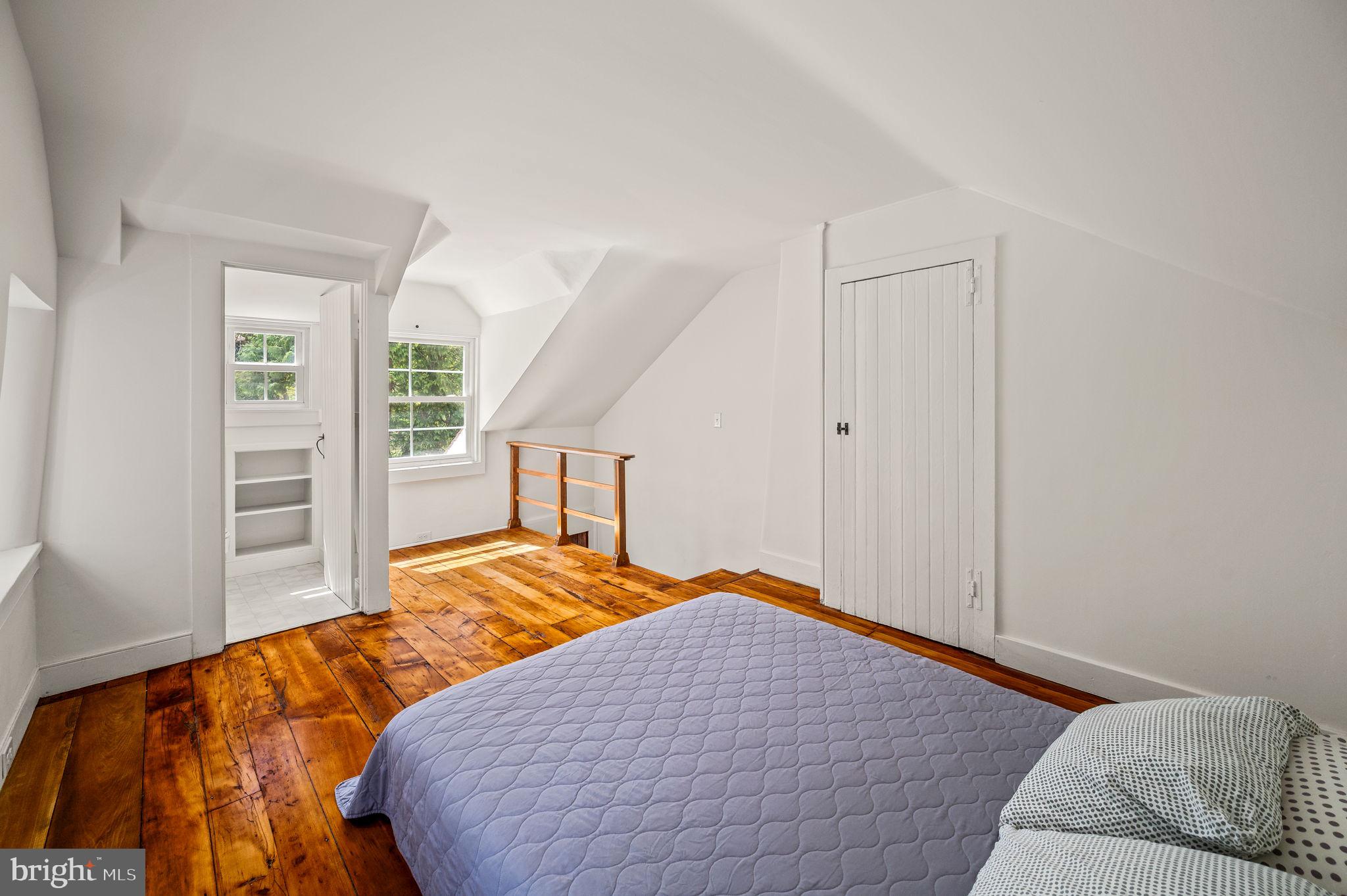 73 West Rose Valley Road Rose Valley, PA 19086 - Photo 23 of 38 a bedroom with a bed and wooden floor