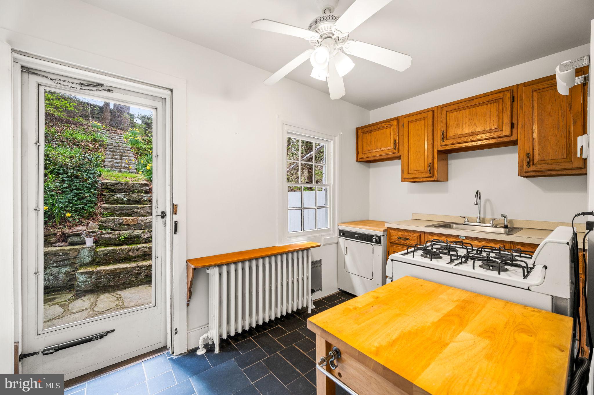 73 West Rose Valley Road Rose Valley, PA 19086 - Photo 9 of 38 a view of a kitchen with a sink and wooden floor