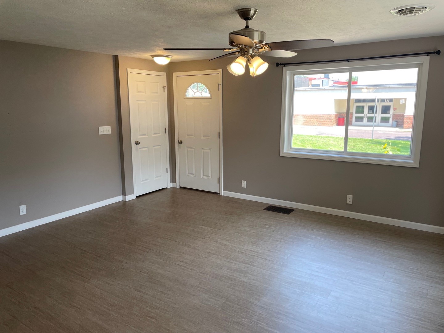 304 South Webster Street Mackinaw, IL 61755 - Photo 11 of 25 an empty room with window chandelier fan and windows