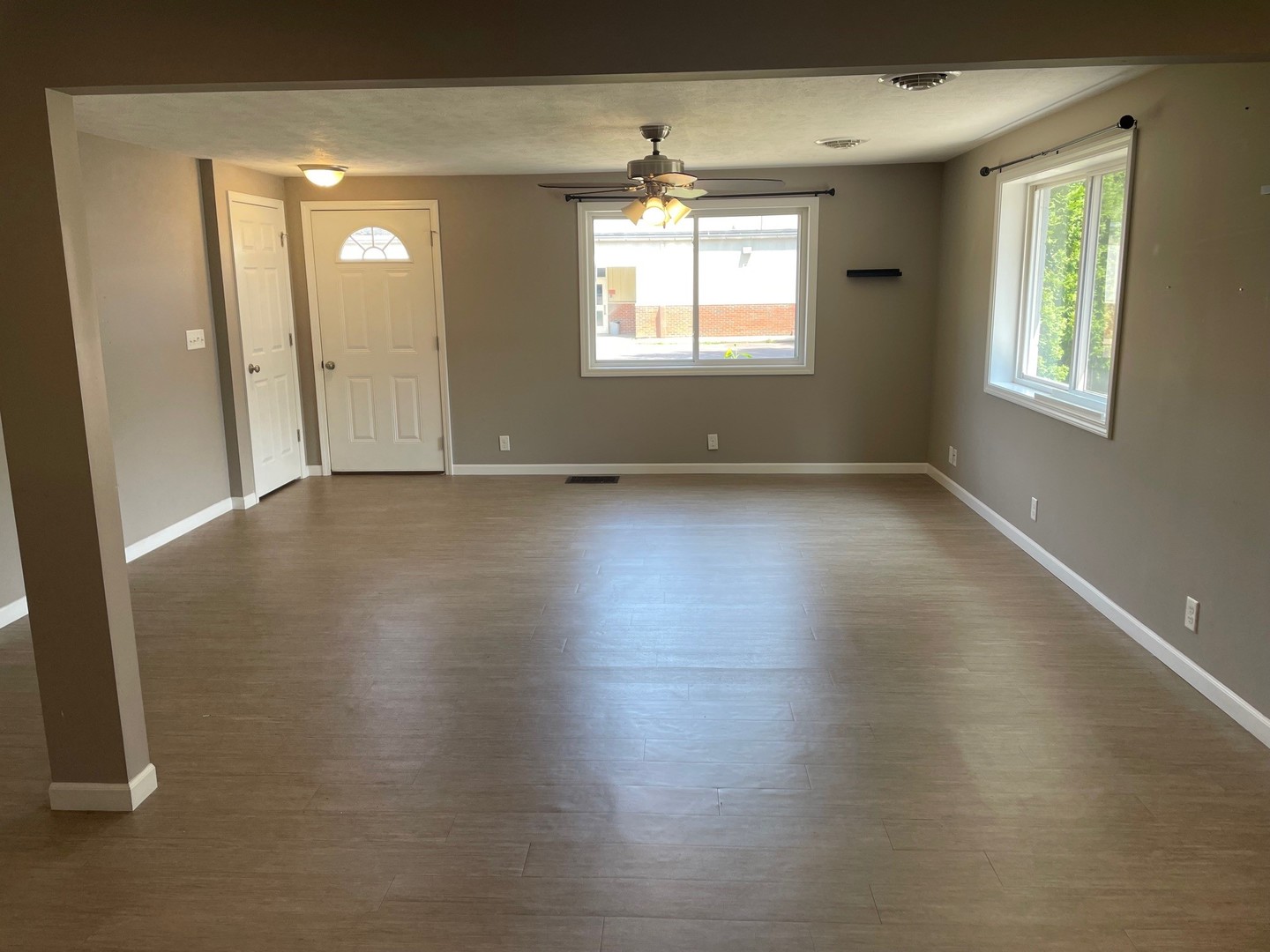 304 South Webster Street Mackinaw, IL 61755 - Photo 14 of 25 an empty room with wooden floor and windows