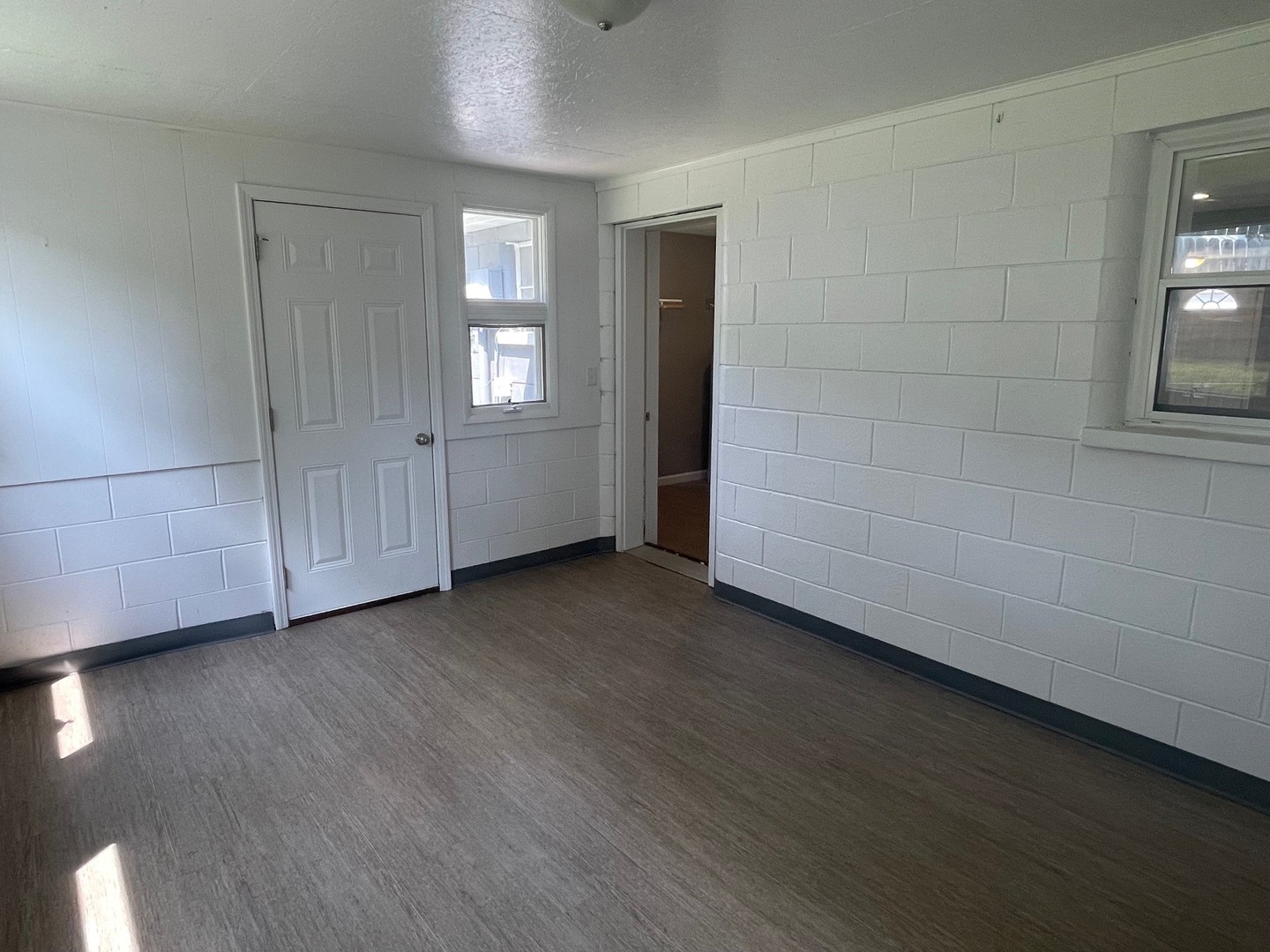 304 South Webster Street Mackinaw, IL 61755 - Photo 15 of 25 a view of an empty room with window and wooden floor