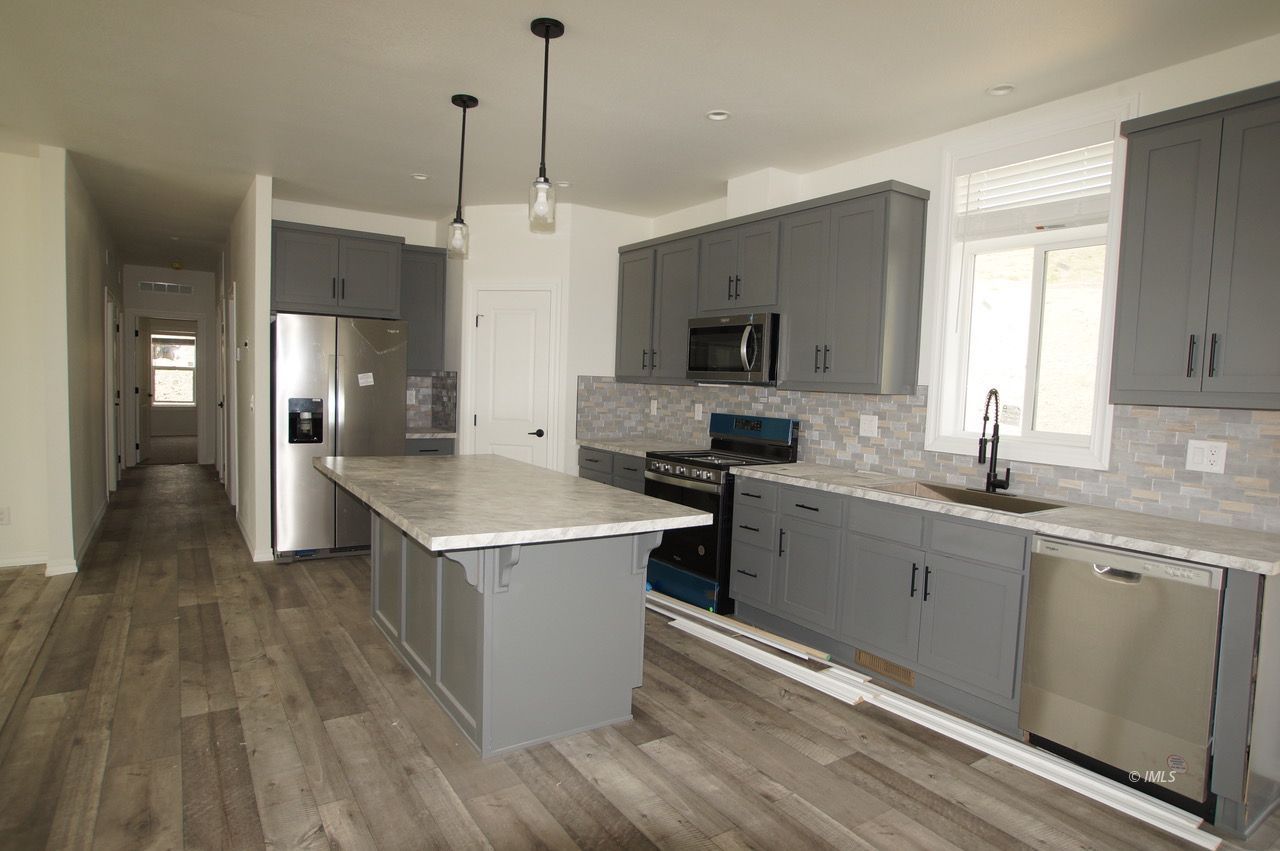 196 Tuolumne Road Bishop, CA 93514 - Photo 11 of 28 a kitchen with a sink stove and refrigerator