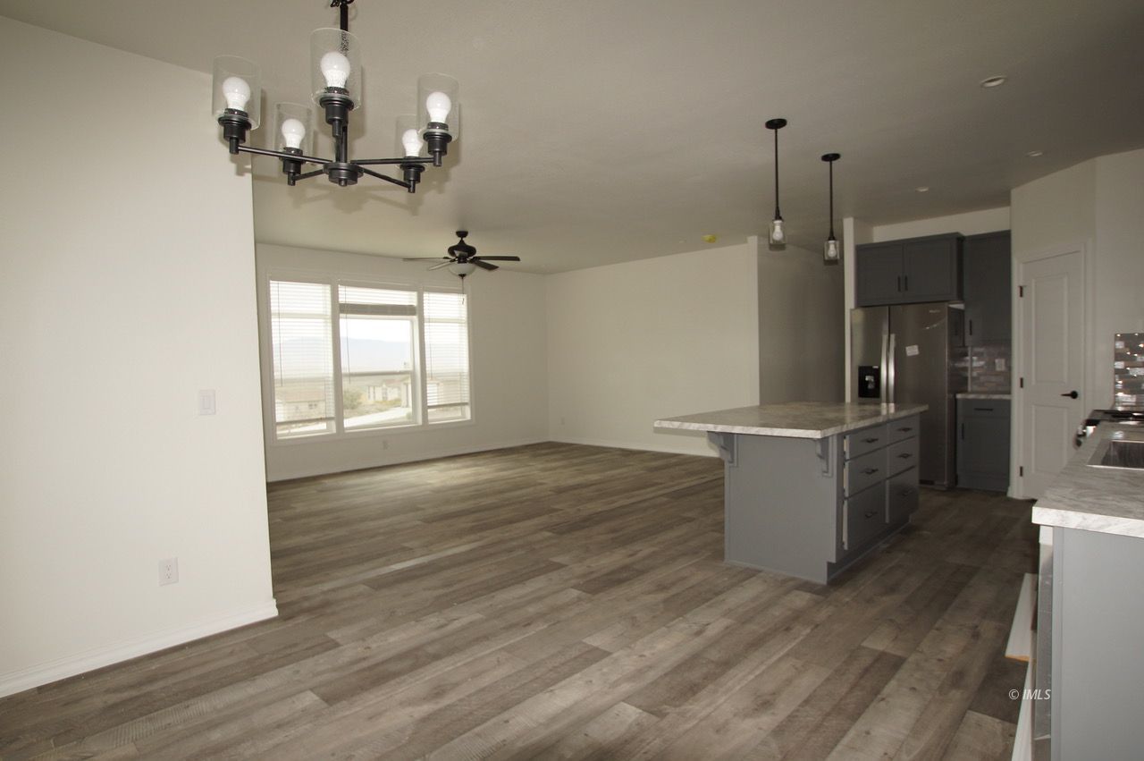 196 Tuolumne Road Bishop, CA 93514 - Photo 14 of 28 a view of a room with wooden floor and windows