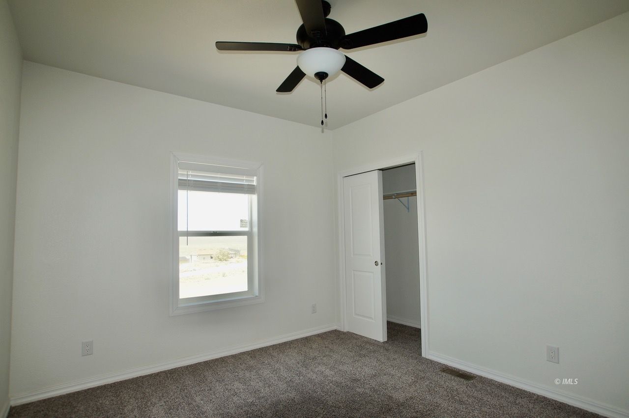 196 Tuolumne Road Bishop, CA 93514 - Photo 22 of 28 an empty room with a window and a fan