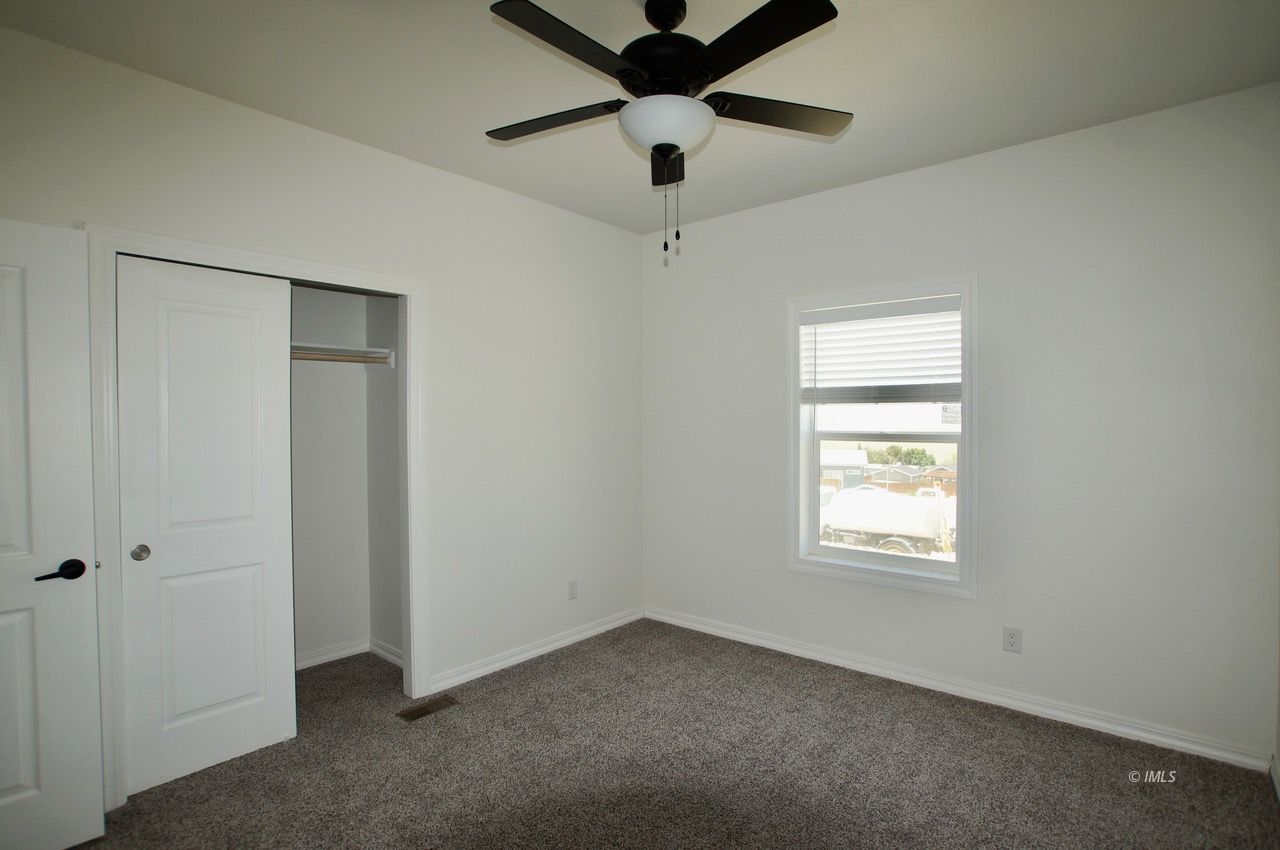 196 Tuolumne Road Bishop, CA 93514 - Photo 23 of 28 an empty room with a window and a fan