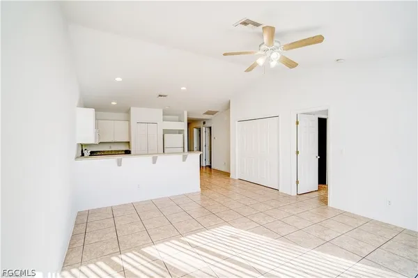 a view of kitchen with refrigerator cabinets and wooden floor