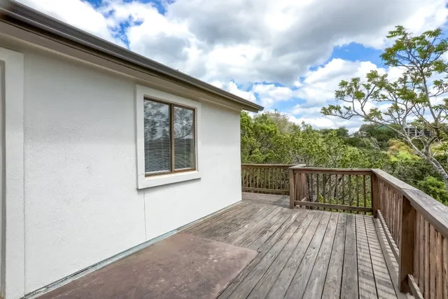 a balcony with wooden floor and fence