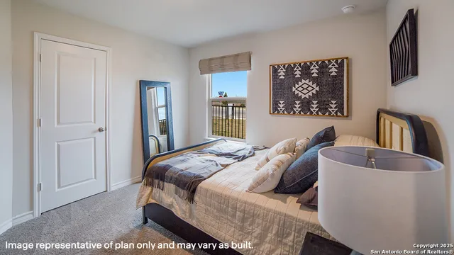 a bedroom with bed and cupboard