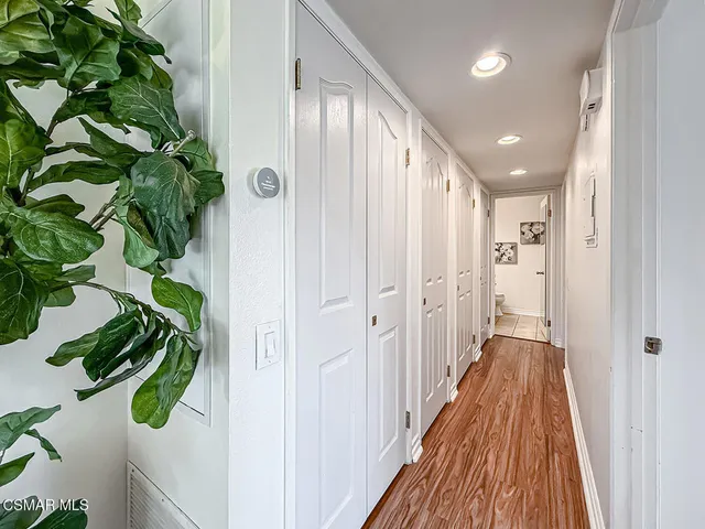 a view of a hallway with wooden floor