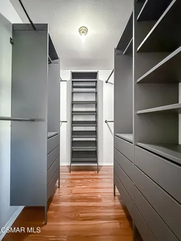 a view of walk in closet with empty racks