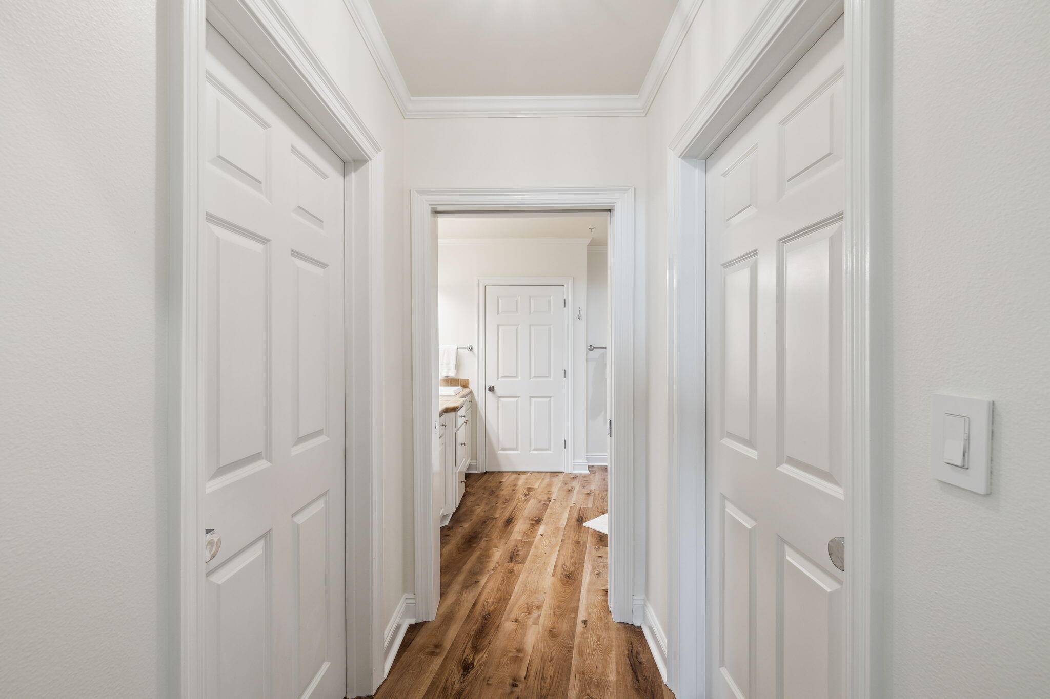 56 Blue Mountain Road, Unit B105 Santa Rosa Beach, FL 32459 - Photo 44 of 98 a view of a hallway with wooden floor and closet