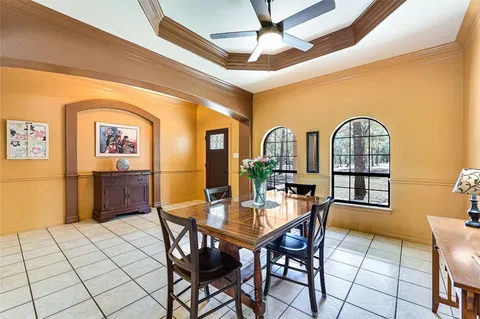 a view of a dining room with furniture and chandelier