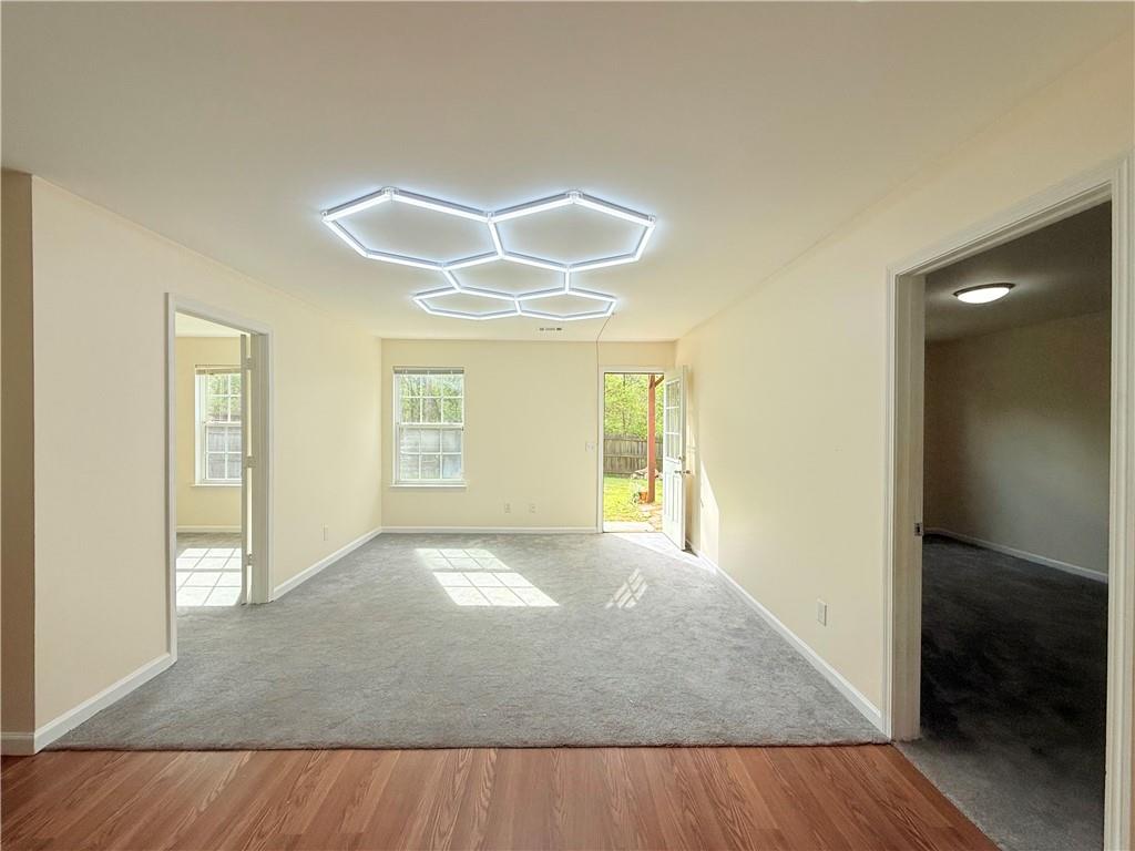 893 Hawthorn Lane Grayson, GA 30017 - Photo 4 of 11 wooden floor in an empty room with a window