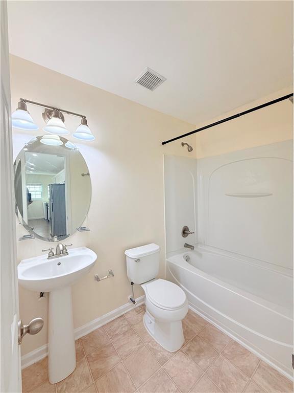 893 Hawthorn Lane Grayson, GA 30017 - Photo 7 of 11 a bathroom with a toilet sink and shower
