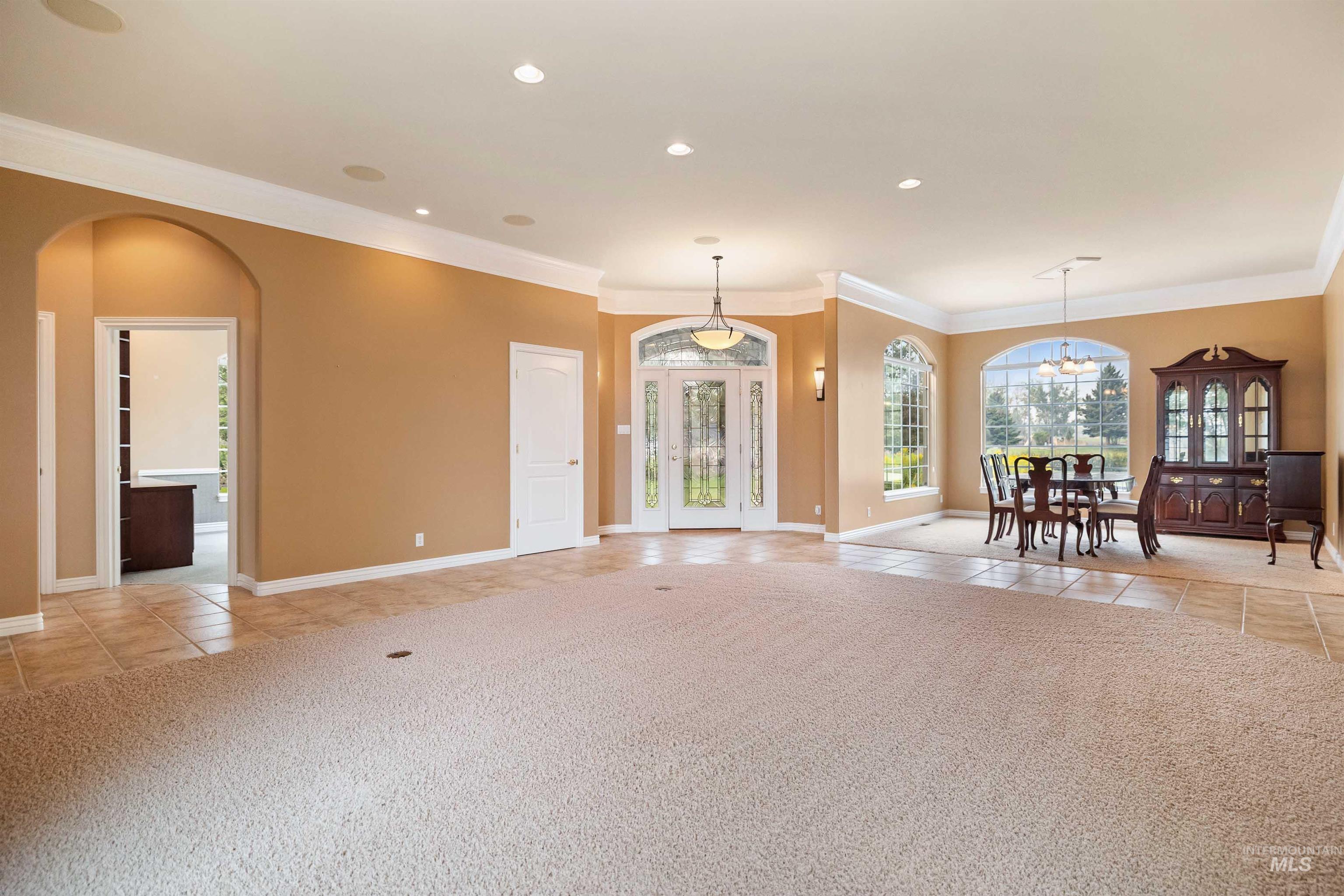 3404 Ridge Line Drive Kimberly, ID 83341 - Photo 6 of 50 Spacious interior featuring a carpeted main area, tile flooring, recessed lighting, and crown molding