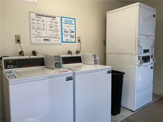 a view of a patio with table and chairs with wooden floor and fence