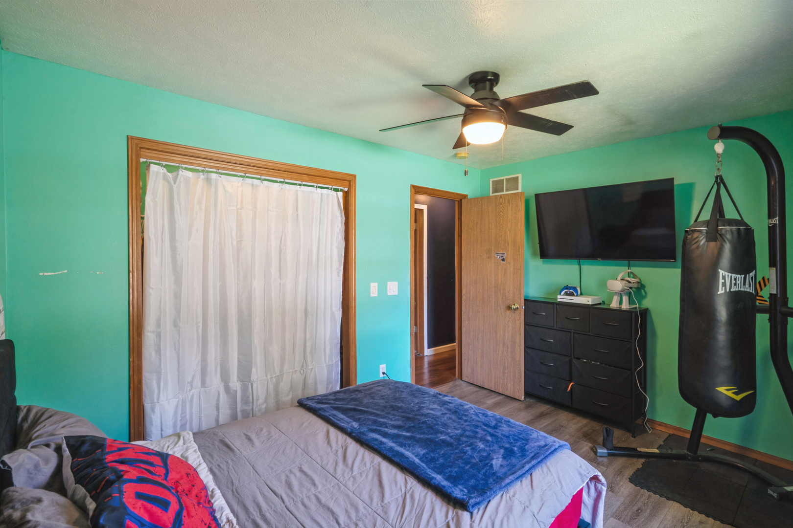 5444 10th Avenue Moline, IL 61265 - Photo 11 of 20 a bedroom with a bed and a flat tv screen on dresser
