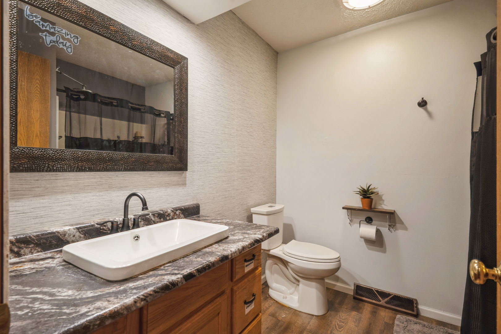 5444 10th Avenue Moline, IL 61265 - Photo 12 of 20 a bathroom with a toilet a sink and mirror