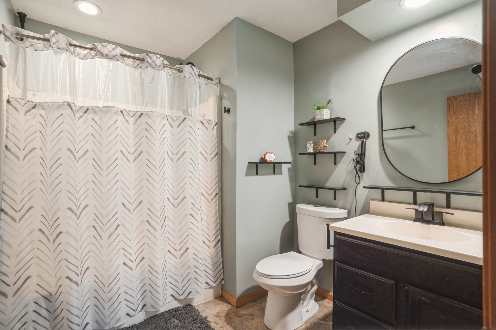 5444 10th Avenue Moline, IL 61265 - Photo 15 of 20 a bathroom with a sink a toilet and shower curtain