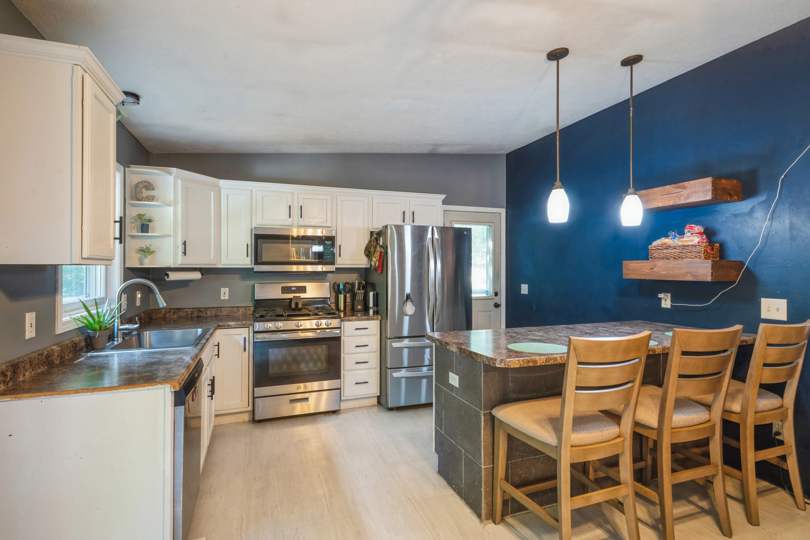5444 10th Avenue Moline, IL 61265 - Photo 7 of 20 a kitchen with stainless steel appliances granite countertop a stove top oven a sink dishwasher and a refrigerator