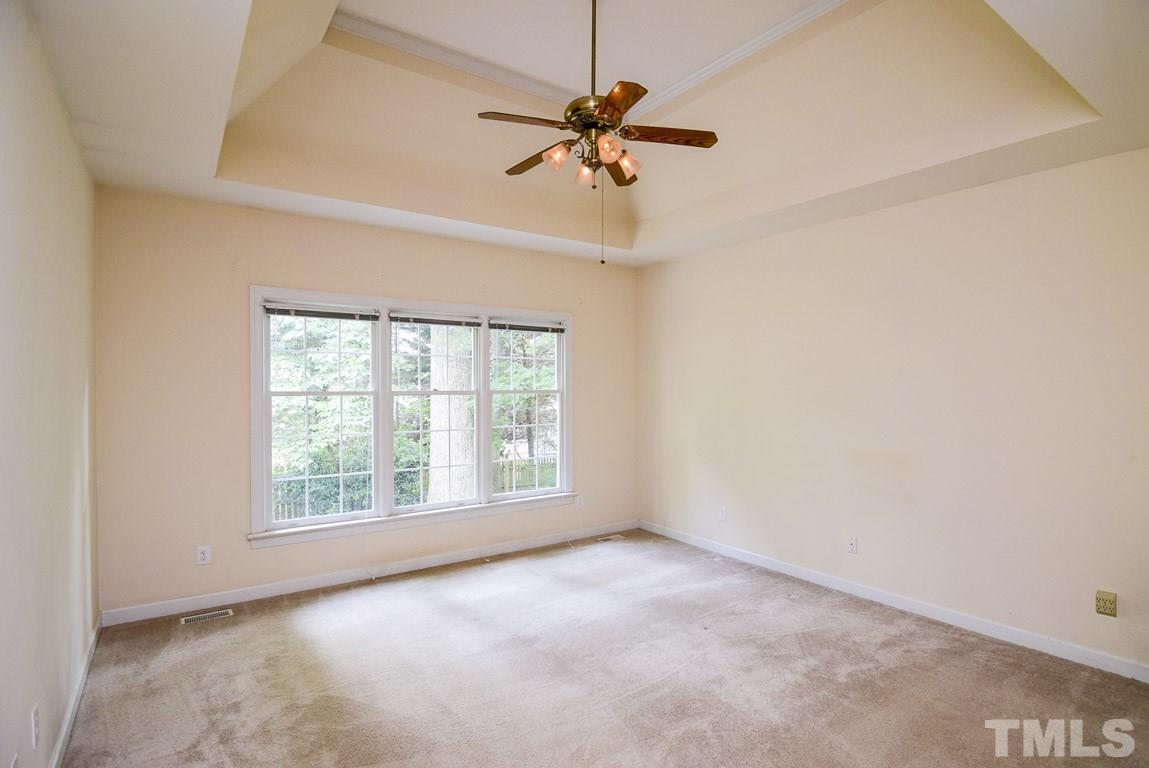 8808 Salute Street Raleigh, NC 27615 - Photo 11 of 25 Large 1st Floor Master Bedroom with Ceiling Fan and Trey Ceiling. Beautiful view to back yards.