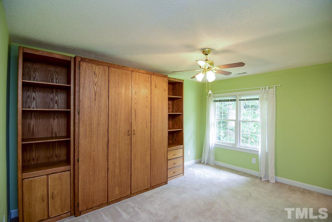 8808 Salute Street Raleigh, NC 27615 - Photo 14 of 25 Guest bedroom with private bathroom, murphy bed system and walk-in closet, would be a fantastic in-law suite.