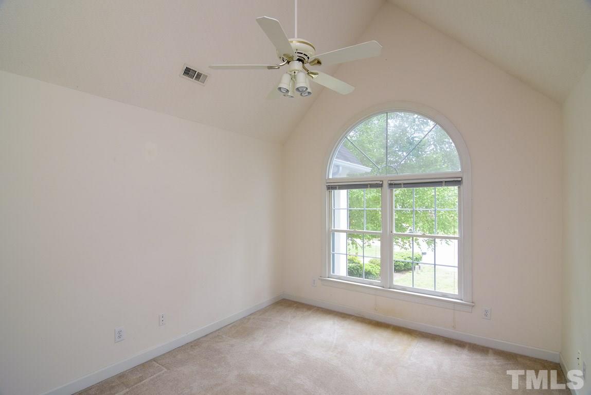 8808 Salute Street Raleigh, NC 27615 - Photo 15 of 25 Beautiful palladium window and vaulted ceiling make this room very special. Also has a walk-in-storage, which is completely floored and can easily be finished making this one of the largest rooms in the house.