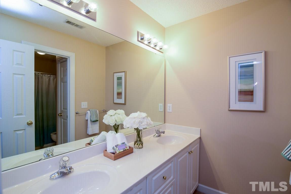 8808 Salute Street Raleigh, NC 27615 - Photo 18 of 25 Second guest bath has double vanity and was newly painted.
