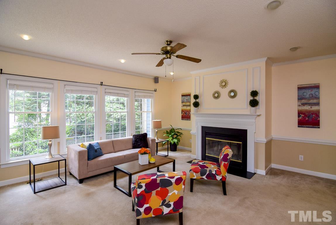 In the family room is plenty of seating area for conversation and watching television. There is also surround sound, a fireplace and a ceiling fan.