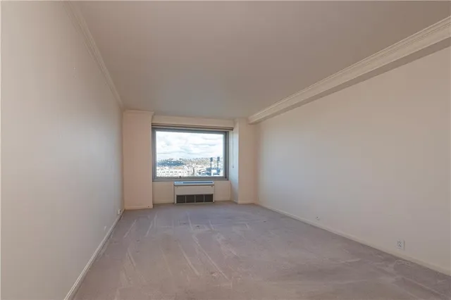 a view of an empty room and fire place