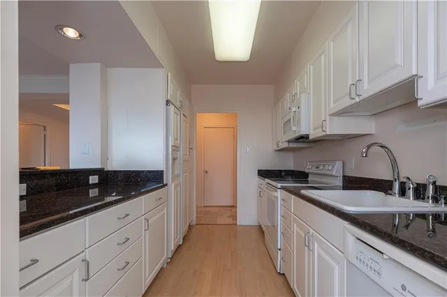 a white toilet sitting next to a bathroom sink