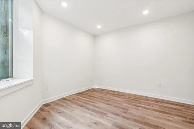 a view of room with wooden floor and fan