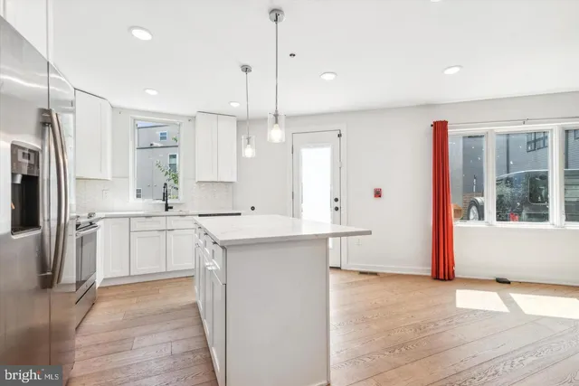 a kitchen with a sink stove and refrigerator
