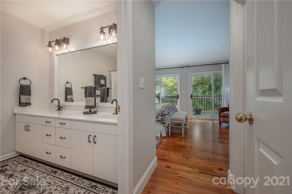 33 Hunting Country Trail Tryon, NC 28782 - Photo 13 of 34 a bathroom with sinks a large mirror and a shower