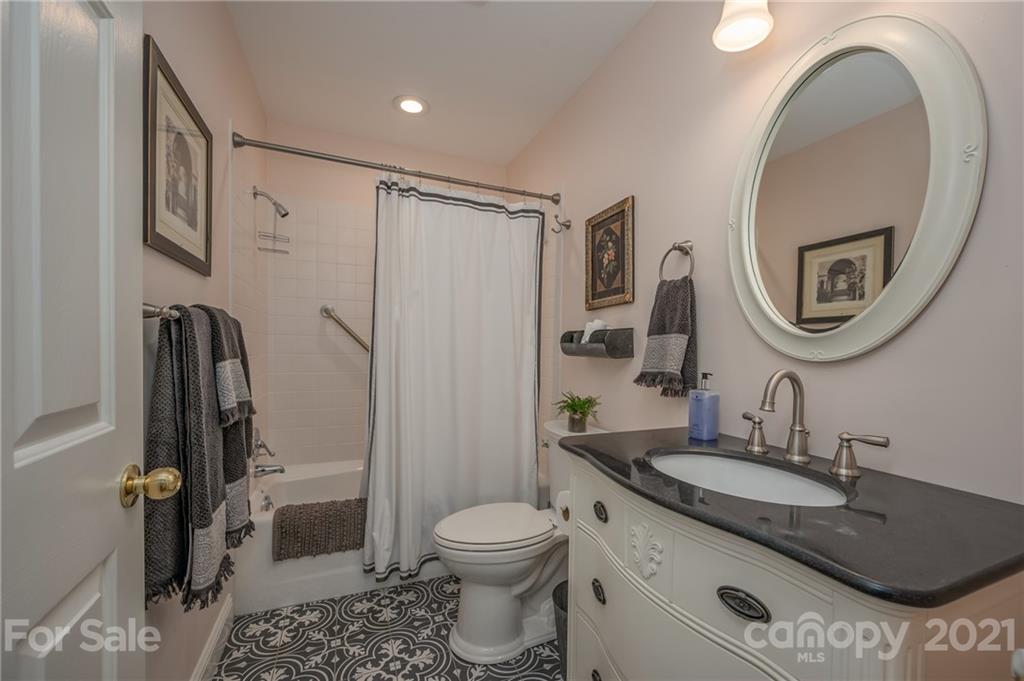 33 Hunting Country Trail Tryon, NC 28782 - Photo 18 of 34 a bathroom with a granite countertop sink toilet and shower