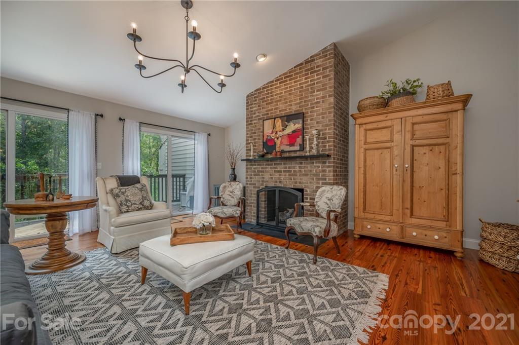 33 Hunting Country Trail Tryon, NC 28782 - Photo 4 of 34 a living room with furniture a flat screen tv and a fireplace