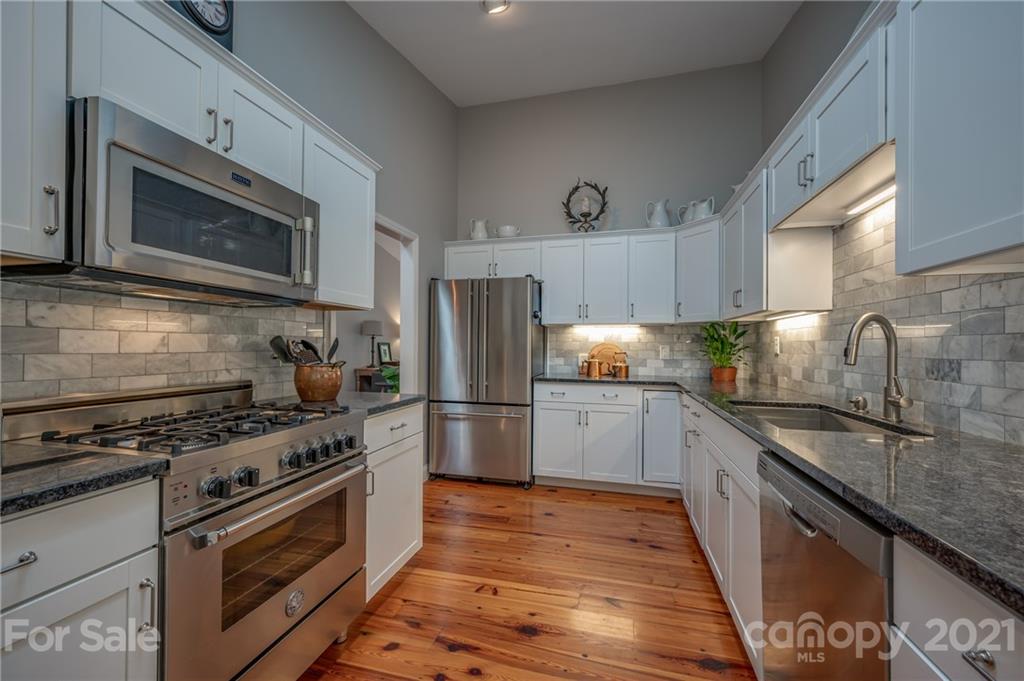 33 Hunting Country Trail Tryon, NC 28782 - Photo 7 of 34 a kitchen with granite countertop a sink stove and refrigerator