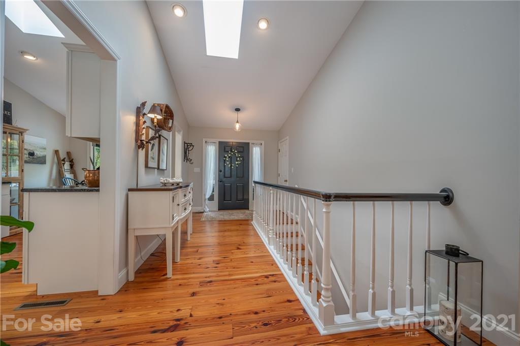 33 Hunting Country Trail Tryon, NC 28782 - Photo 10 of 34 a view of a hallway with wooden floor and staircase