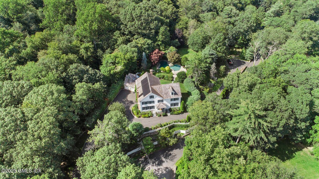 an aerial view of a house with a yard