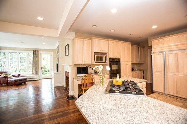5 Hewins Farm Road Wellesley, MA 02481 - Photo 15 of 18 a view of a kitchen with kitchen island granite countertop a refrigerator oven stove and a large window with wooden floor