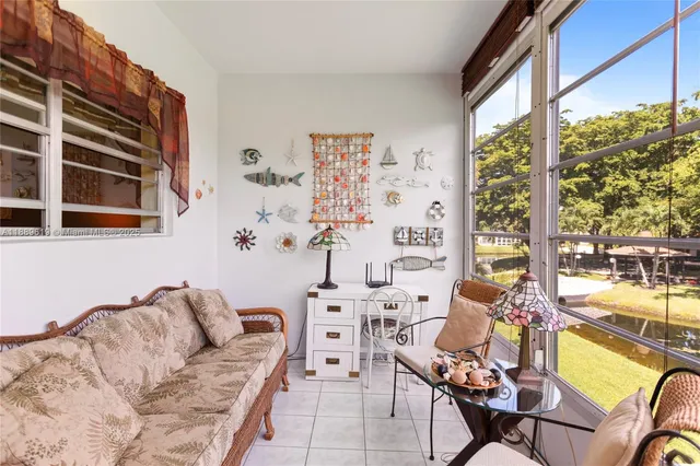 a living room with furniture and a floor to ceiling window