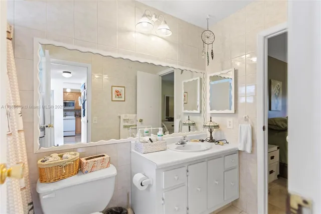 a bathroom with a double vanity sink mirror and toilet